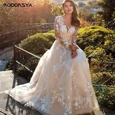 a woman in a wedding dress sitting on stairs with her hand on her hip and looking off to the side