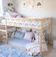 a child's bedroom with a bunk bed and rainbow pillows on the bottom shelf