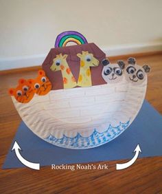 a paper boat that has animals in it