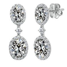 pair of earrings with round cut diamonds on top and pave set in the bottom