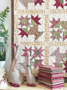 a table topped with lots of different types of quilts and vases next to each other