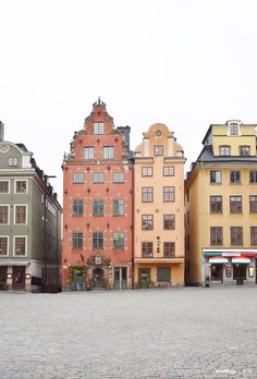 the buildings are all different colors and have many windows on each side, but there is no one in them