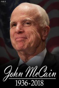 a man in a suit and tie with an american flag behind him that says john mccain