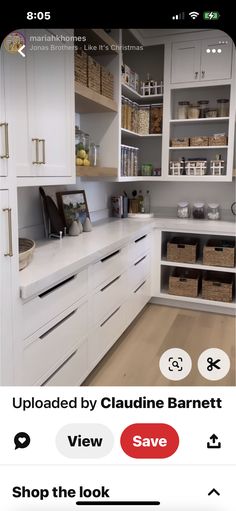 an image of a kitchen with white cabinets and drawers on the left side of the screen