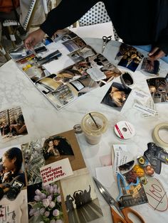 a table topped with lots of pictures and scissors