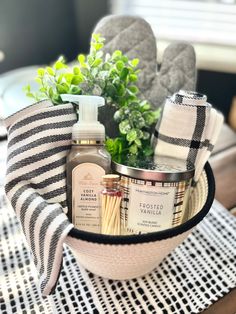 a basket filled with items sitting on top of a wooden table next to a potted plant