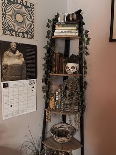 there is a shelf with books on it in the corner next to a wall calendar