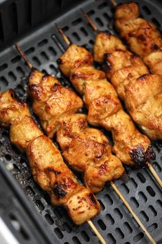 chicken skewers are being cooked on the grill