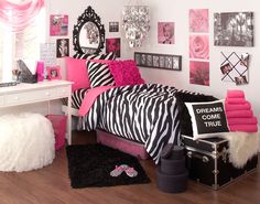 a bedroom decorated in pink and black with zebra print bedding, pillows, rugs and decor