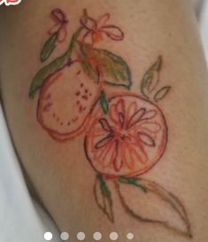 a tattoo with oranges and leaves on it