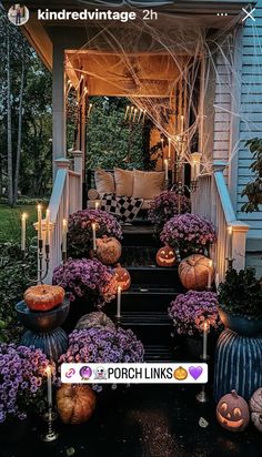 an outdoor porch decorated for halloween with pumpkins and flowers on the steps, surrounded by candles