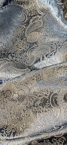 an old silver paisley fabric with black and white designs