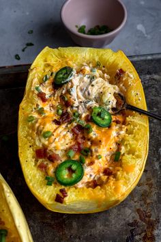 the stuffed squash is topped with bacon, green peppers and cheese