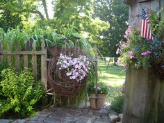 an outdoor garden with flowers and plants in pots