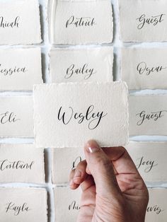 a person holding up a piece of paper with the word wysley written on it