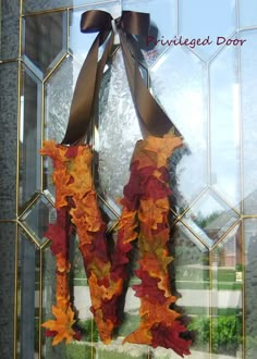 an autumn wreath hanging on the front door