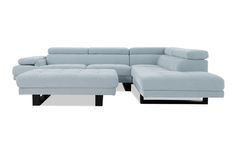 a blue sectional sofa with ottoman and footstool in front of a white background