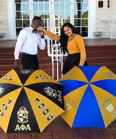 two people standing next to each other holding umbrellas