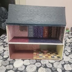 a doll house made out of cardboard sitting on top of a table