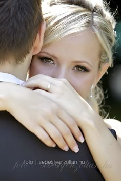 a young man and woman embracing each other