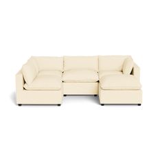 a white sectional couch sitting on top of a white floor