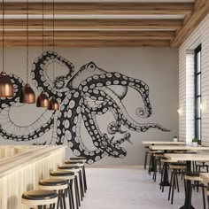 an octopus mural on the wall of a restaurant with tables and stools in front of it