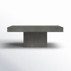 a concrete table sitting on top of a white floor