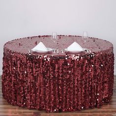 a red sequin table cloth with wine glasses on it