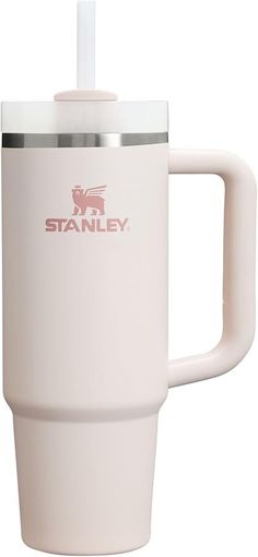 a white coffee cup with a straw in it's mouth and stanley logo on the side