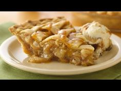 a slice of apple pie on a plate with ice cream and caramel drizzle