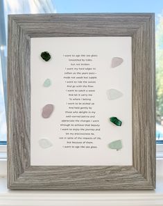 a framed poem with sea glass on it