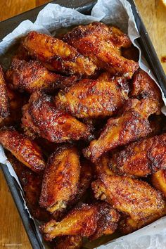 fried chicken wings in a pan on a wooden table