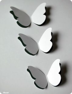 four pieces of paper cut out to look like butterflies