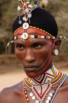 an african man with beaded headdress and necklaces