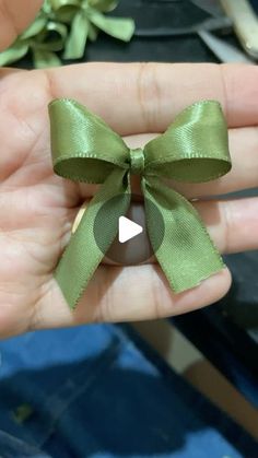 a person is holding an olive with a bow on it