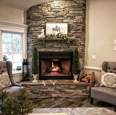 a living room filled with furniture and a fire place in the middle of a fireplace