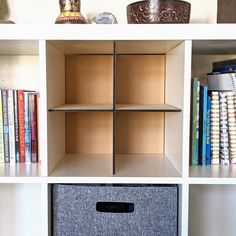 the bookshelf is filled with different types of books and other things on it