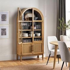 a wooden china cabinet with glass doors in a dining room