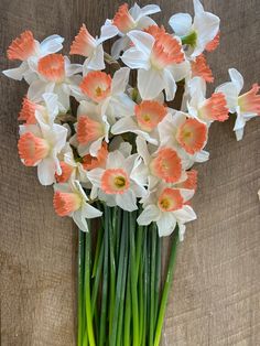 a vase filled with white and orange flowers