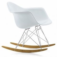 a white rocking chair with wooden legs