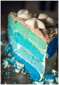 a slice of cake with blue and green frosting