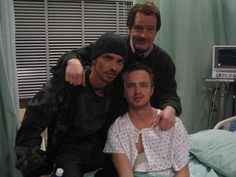 two men in hospital gowns are posing for the camera while one man is pointing at the camera