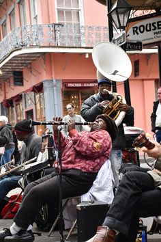 some people are playing instruments in the street