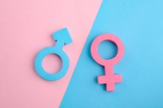 a pink and blue female symbol next to a male sign on a blue and pink background