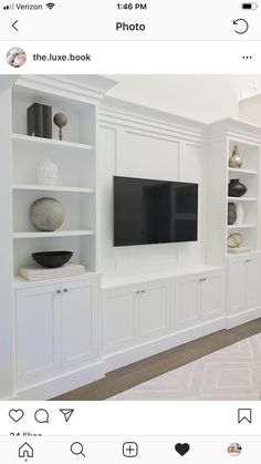 a white entertainment center with built in bookshelves