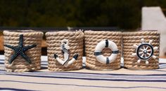 three nautical themed containers sitting on top of a table