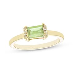 This petite ring is the perfect little pop of color to dress up your finger. Created in 10K yellow gold, the design features a baguette-cut peridot set horizontally and flanked by ribbons of diamond accents atop a slender polished shank. Senior Ring, Senior Rings, August Birthstone Ring, Petite Ring, Gold Book, Diamond Accent Ring, Peridot Stone, August Birthstone, August Birth Stone