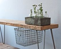 some bottles are sitting on top of a table with hairpin legs and a wire basket