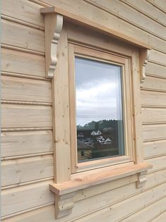 a window on the side of a wooden building