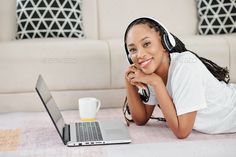 Smiling woman studying at home by DragonImages. Portrait of happy smiling young Black woman with dreadlocks lying on the floor next to her opened laptop #Sponsored #DragonImages, #Portrait, #happy, #home Woman With Dreadlocks, Woman Studying, Studying At Home, Headphones Listening To Music, Women With Dreadlocks, Lying On The Floor, Smiling Woman, Dragon Images, Home Study